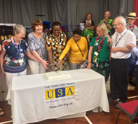 mayor of enfield cutting cake for palmers green and southgate u3a fifth birthday