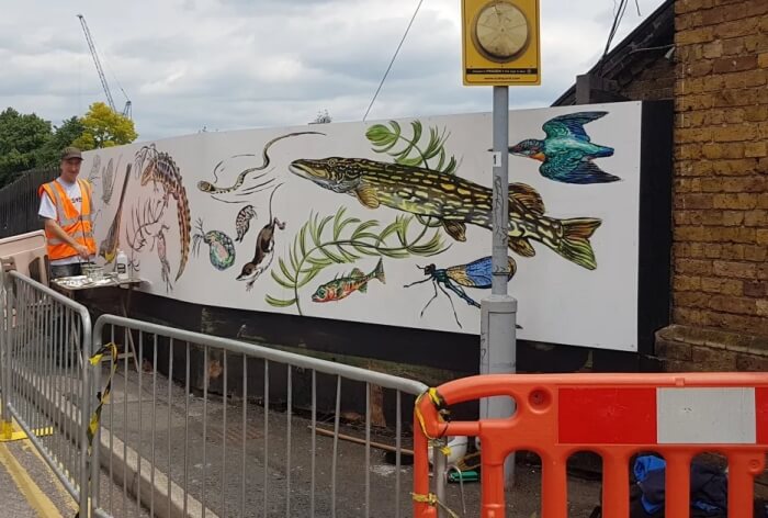 painting the mural at palmers green station