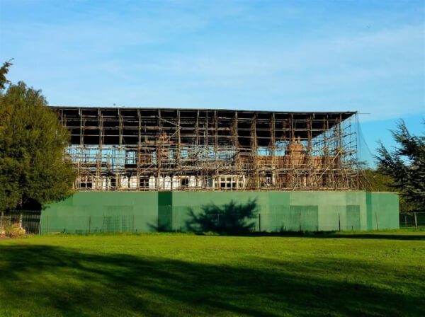 The ruins of Broomfield House swathed in scaffolding and surrounded by a high fence