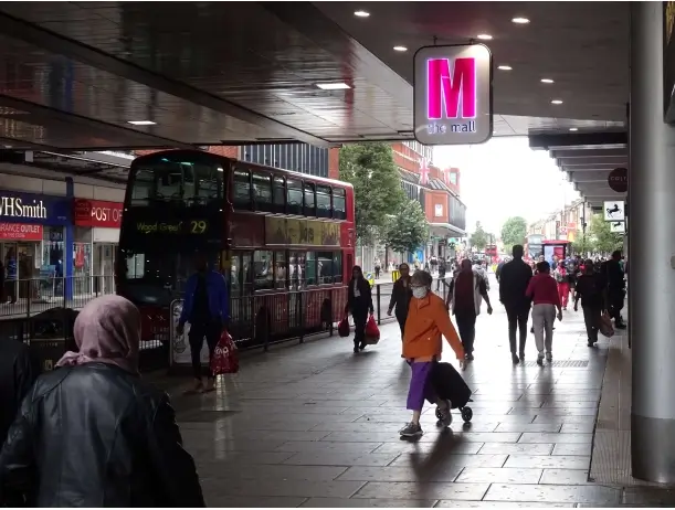 29 bus passing the mall wood green with shoppers walking by