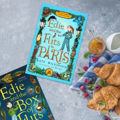 Two Edie books by Kate Wilkinson on a table with a plate of croissants 1