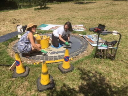 installing learning circle mosaic in conway recreation ground