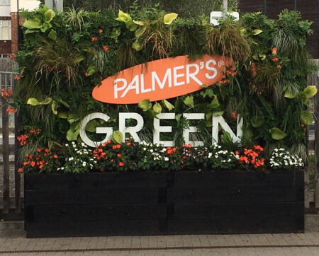large planter on platform 2 at palmers green station decorated by palmers