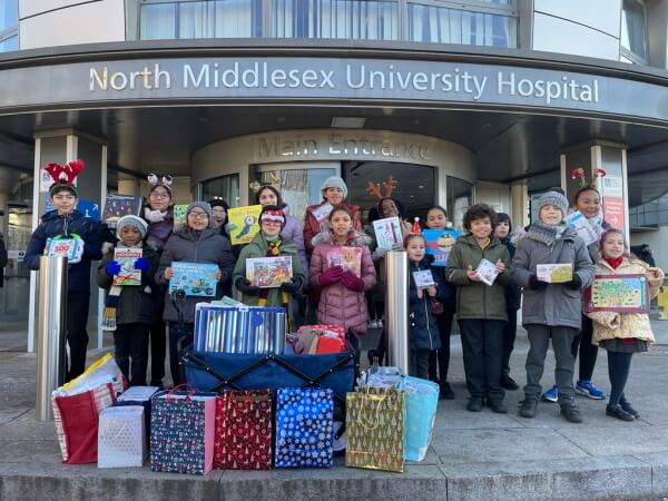 members of oakfield primary school council outside the north middlesex hospital with christmas gifts