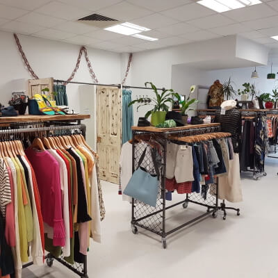 womens garments on racks at philanthropy london shop in palmers green