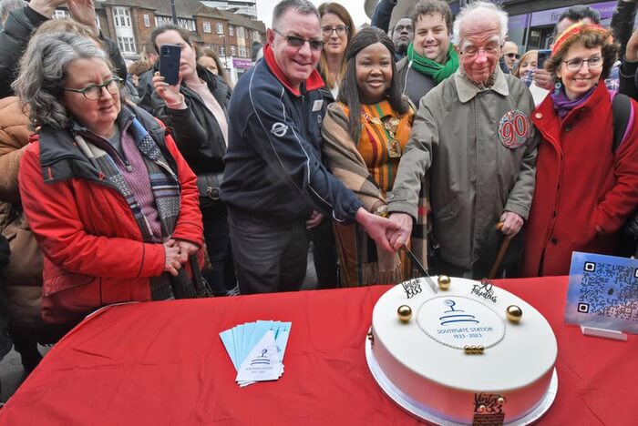 cutting the 90th birthday cake at southgate station march 2023