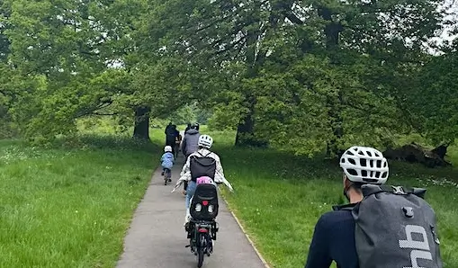 family bike club riding through hilly fields 1