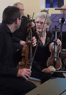 joan bayliss holding a violin