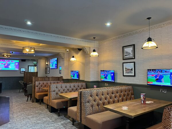 seating and multiple tv screens in the refurbished chestnut tree pub in palmers green